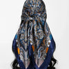 A dark blue and gold floral satin shawl tied in a decorative knot.