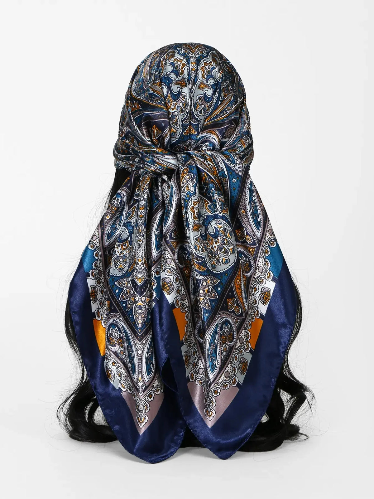 A dark blue and gold floral satin shawl tied in a decorative knot.