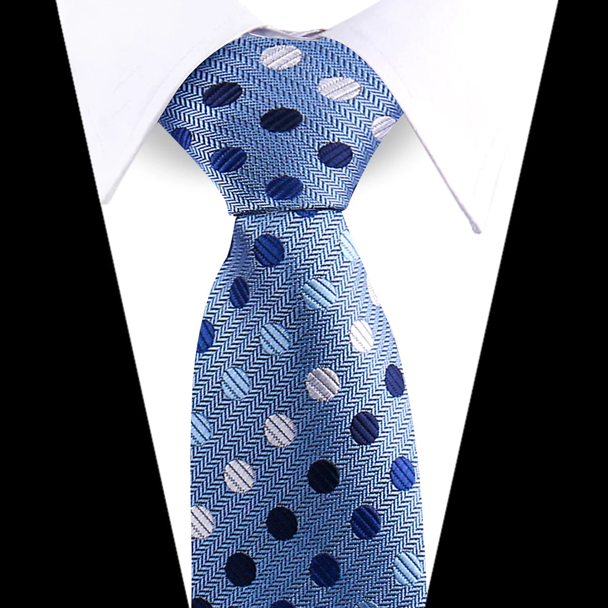 Blue silk necktie with white polka dots and silver accents, tied in a knot.