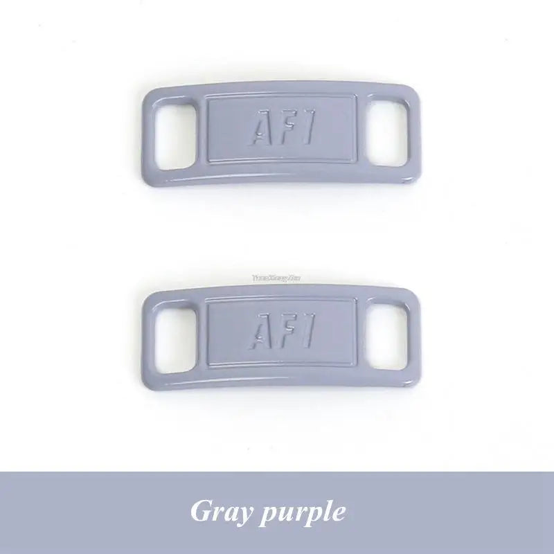 A pair of gray purple diamond shoe charms and laces labeled AF1