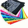 A stack of colorful cotton bandana scarves in various shades including pink, blue, green, yellow, and black.