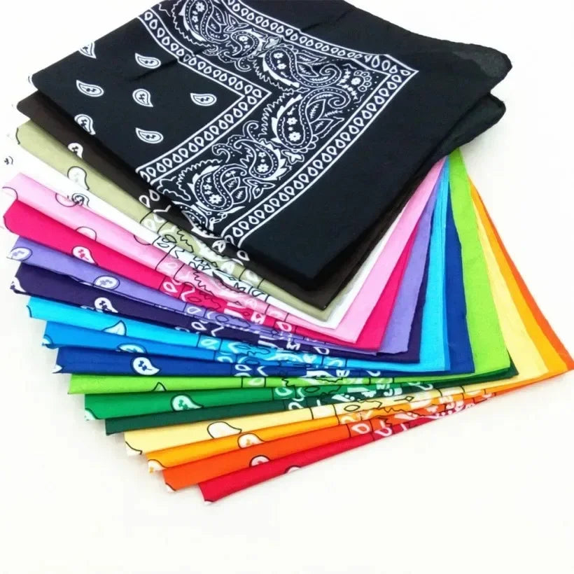 A stack of colorful cotton bandana scarves in various shades including pink, blue, green, yellow, and black.