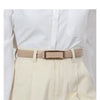 A beige faux leather belt with a gold buckle worn over a white collared shirt and light cream trousers.