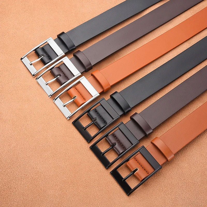 A collection of men's luxury PU leather belts in black and tan colors with silver metal pin buckles.