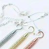 A collection of silver and gold precision jewelry tools for clasps and closures.