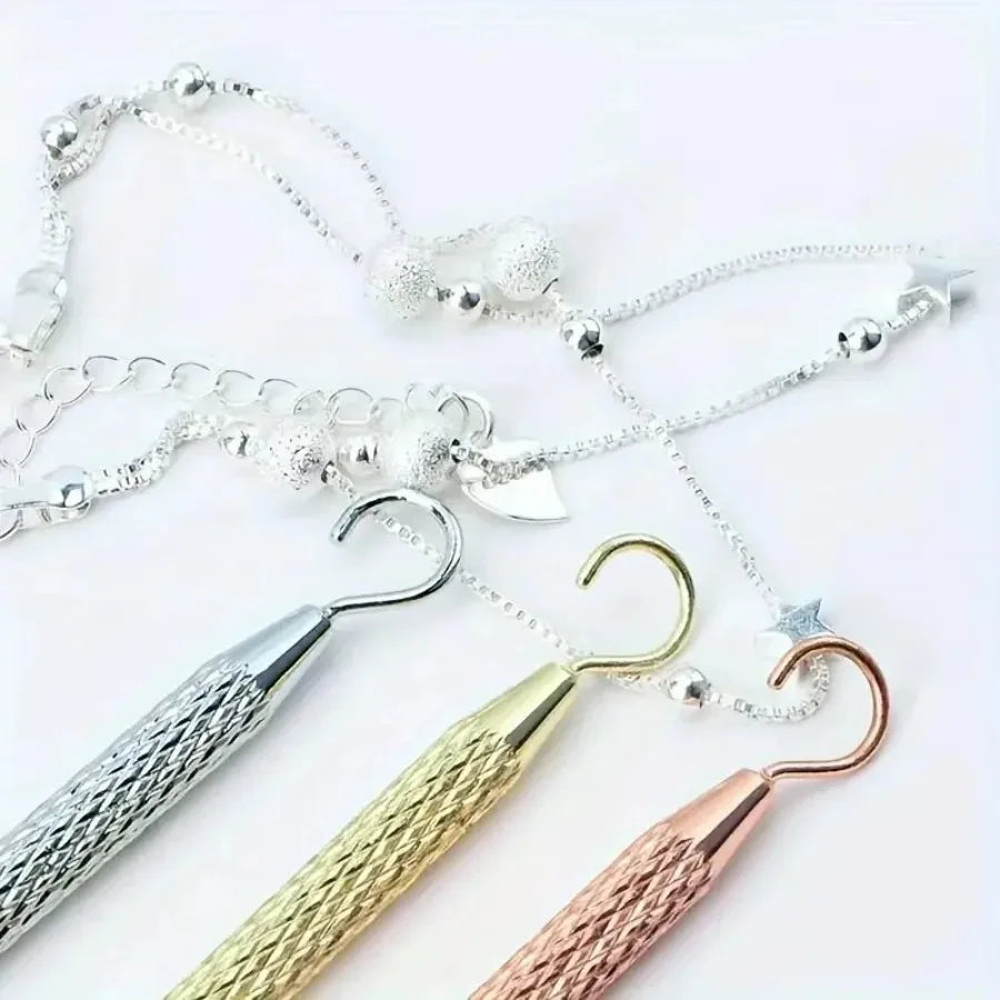 A collection of silver and gold precision jewelry tools for clasps and closures.
