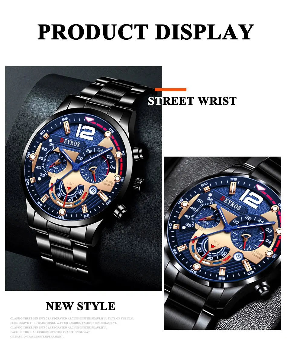 A close-up display of a black stainless steel watch with a blue dial and gold accents, shown on a wrist.