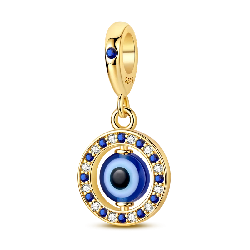 A gold-toned charm bracelet featuring a devil's eye design with blue and black glass eyes.