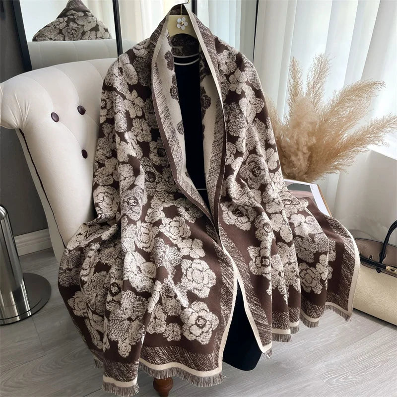A brown and cream patterned luxury plaid cashmere feel scarf and shawl wrap displayed on a hanger.