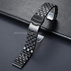 A close-up shot of a black adjustable stainless steel watch band on a dark surface.