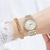 A close-up of an elegant two-tone crystal quartz wristwatch on a wrist, featuring gold and silver tones.