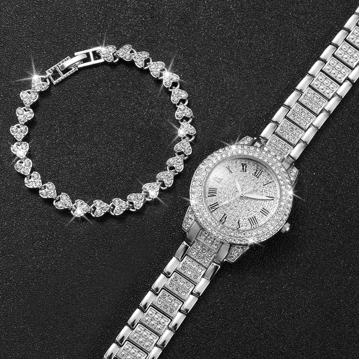 A silver rhinestone heart watch set featuring a bracelet and a wristwatch on a black background.
