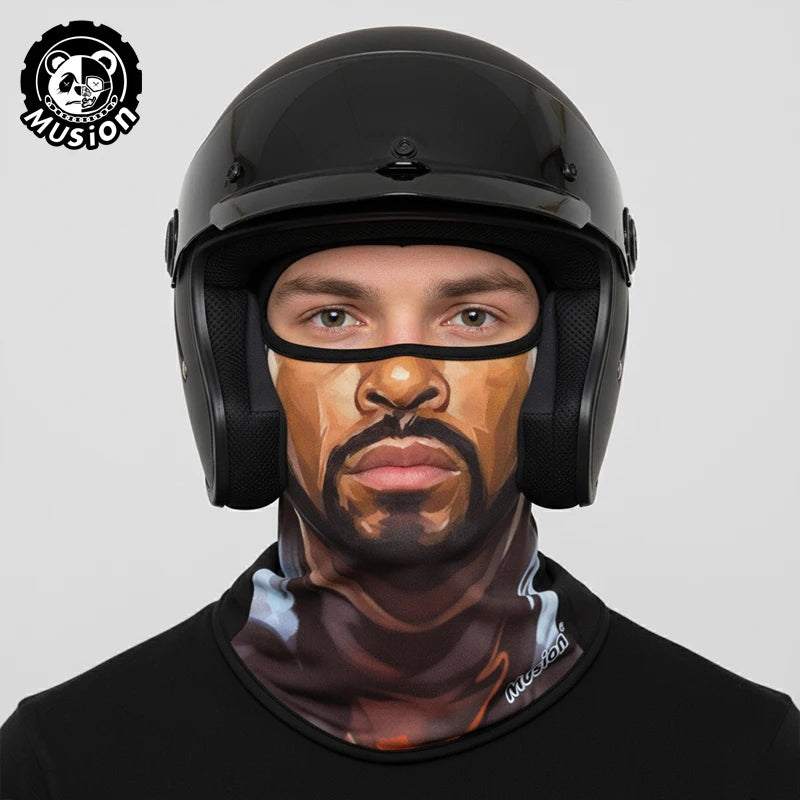 A man wearing a black full face balaclava helmet liner with a tiger face design.