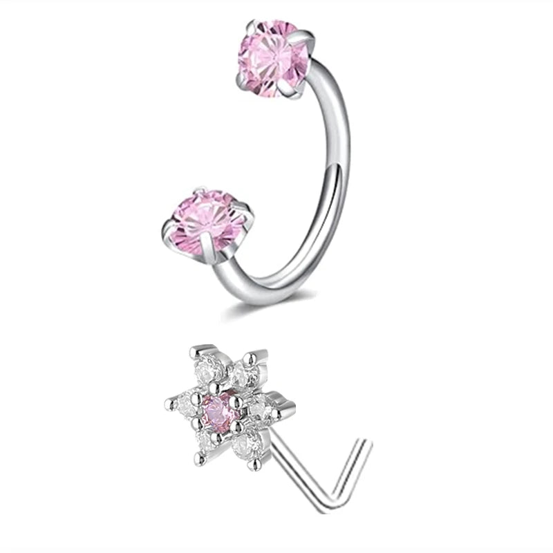 A set of silver horseshoe nose rings featuring pink and clear gemstone accents.