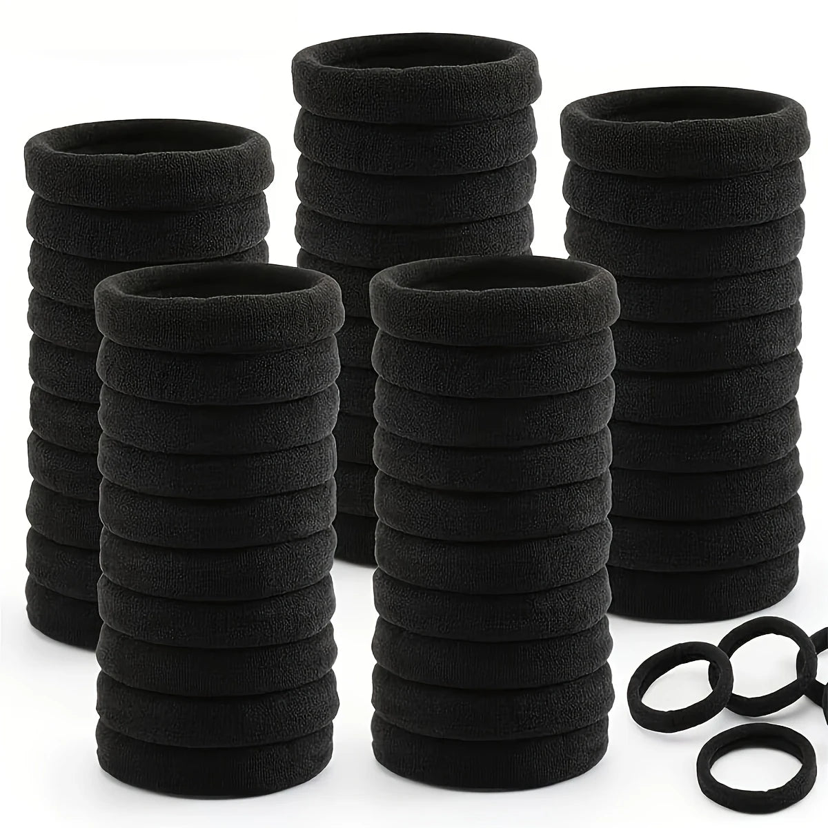 A stack of black seamless elastic hair ties for ponytail holders.