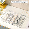 A clear plastic multi-compartment organizer for storing eyeglasses and sunglasses.