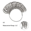 A set of professional metal ring sizers, silver-toned, coiled and arranged for measurement.