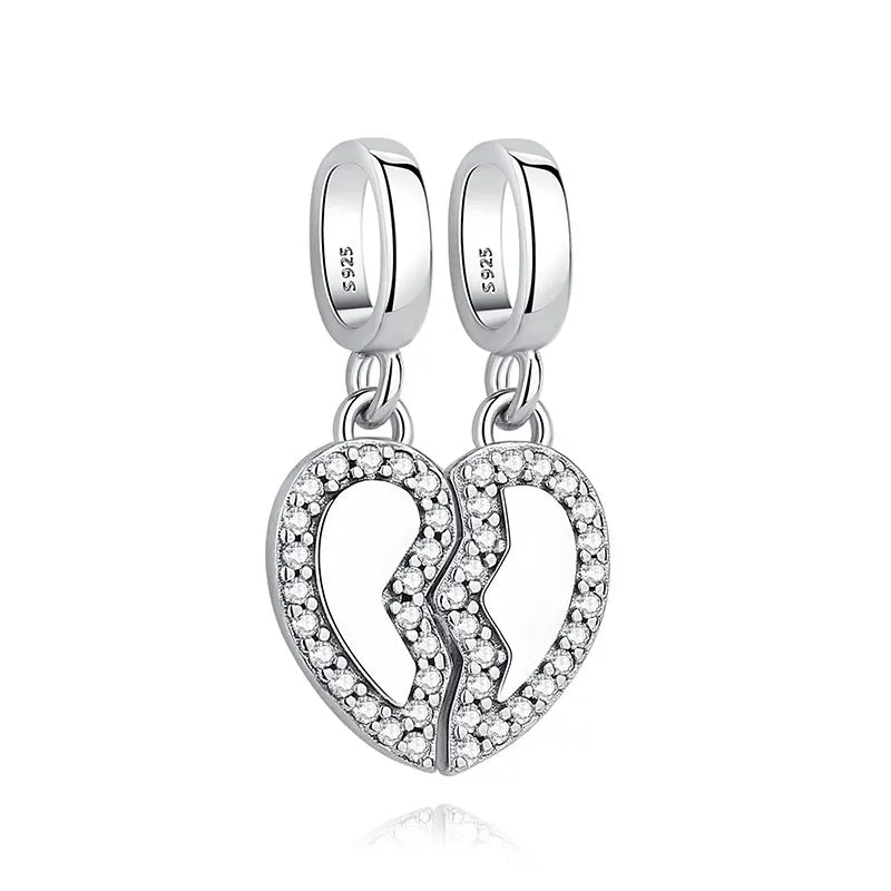 Silver family tree charm jewelry featuring a heart design and a tree silhouette.