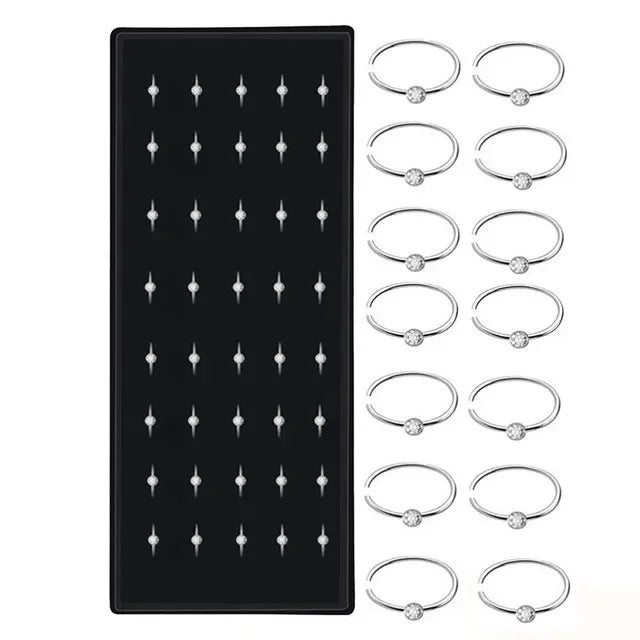 A set of stainless steel nose studs and rings for body piercing