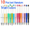 A set of ten bright colored random ballpoint pens with silver tips.