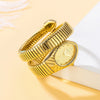 A gold quartz watch with an elegant snake design is displayed on a white surface.