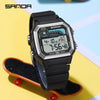 A black digital sports wristwatch with a silver bezel and blue display is shown on an orange skateboard.