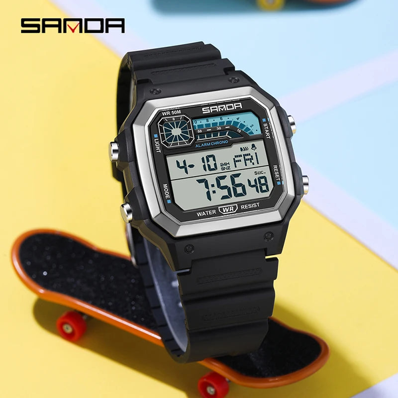 A black digital sports wristwatch with a silver bezel and blue display is shown on an orange skateboard.