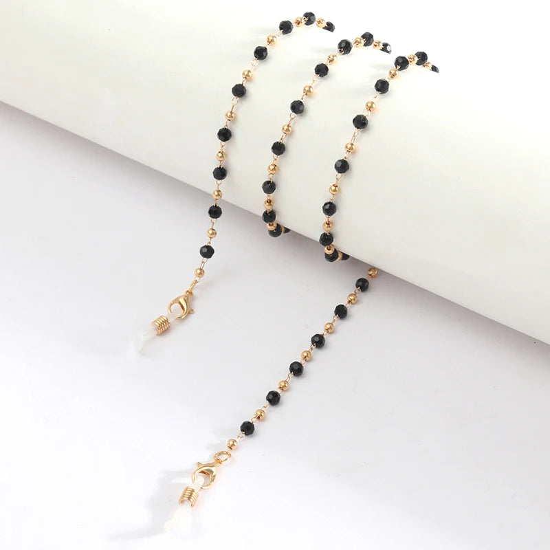 Gold-toned chains with black beads used as lanyards or necklaces
