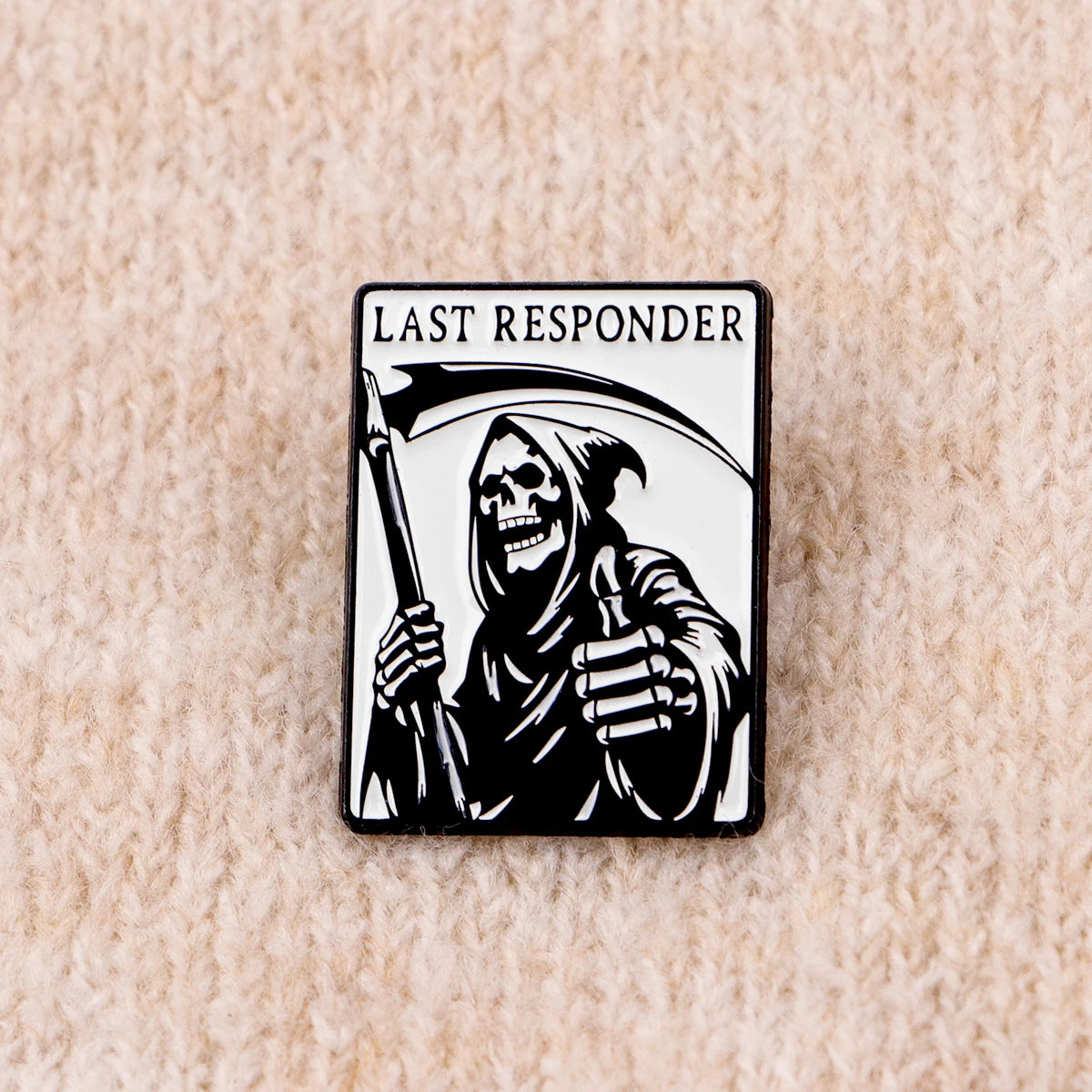 A black enamel pin featuring a skull character with a hood and a sword, labeled LAST RESPONDER.