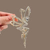 A gold-toned rhinestone butterfly fairy angel hair clip being held by a hand.