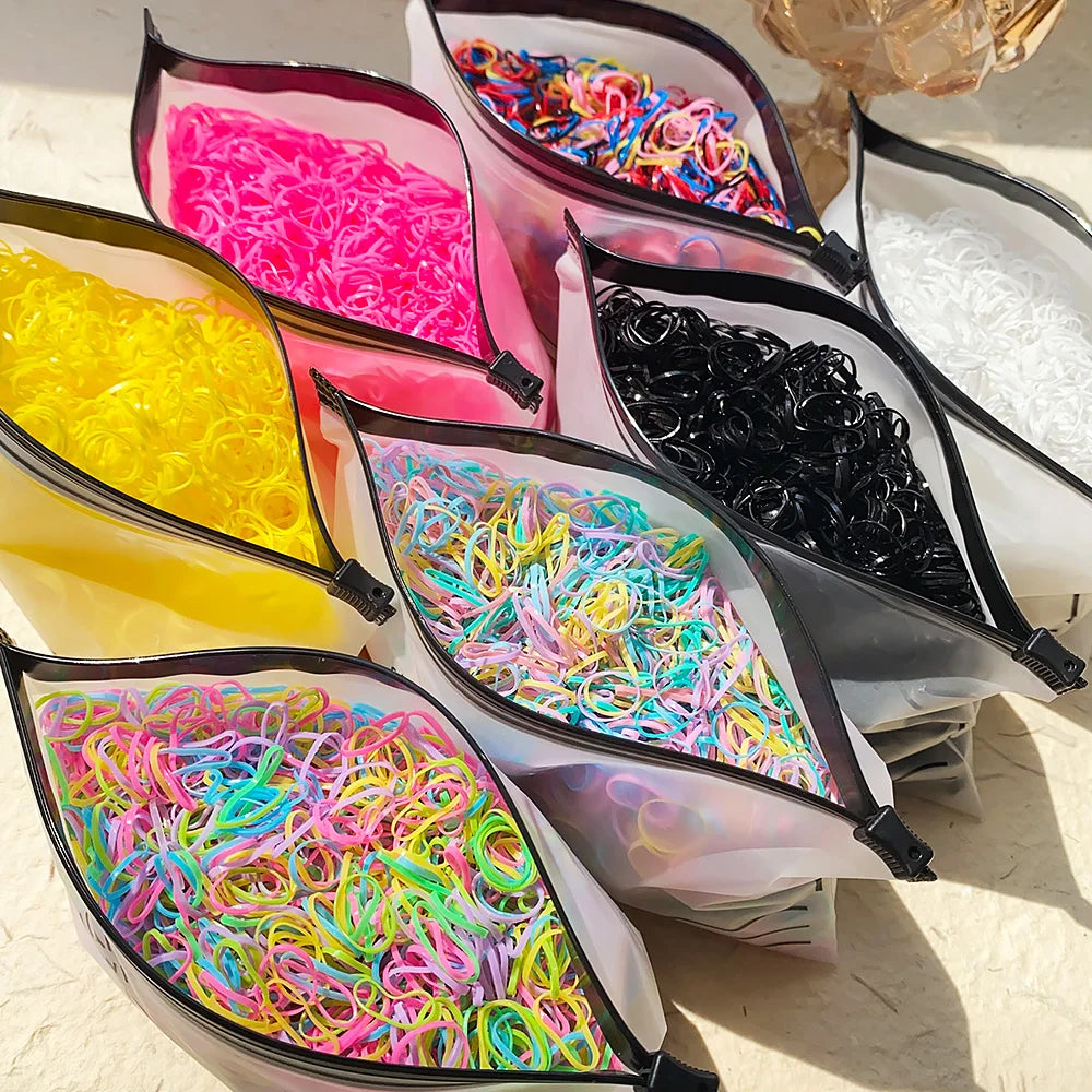 A collection of colorful disposable rubber hair ties in various shades and colors displayed in clear packaging.