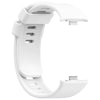 A white replacement silicone watch strap for a smartwatch is shown in a close-up view.