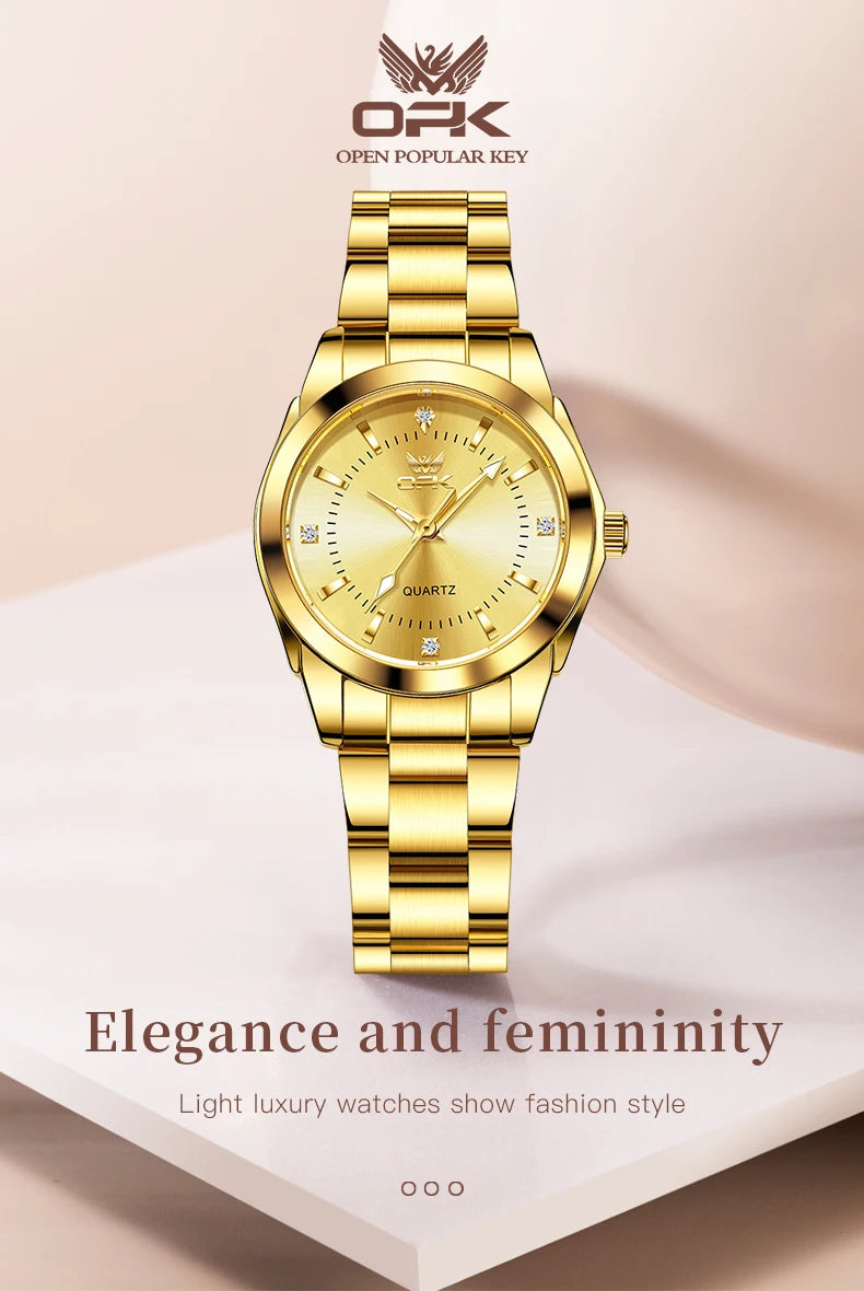A gold-toned quartz watch with a round face and metal bracelet displayed on a white surface.