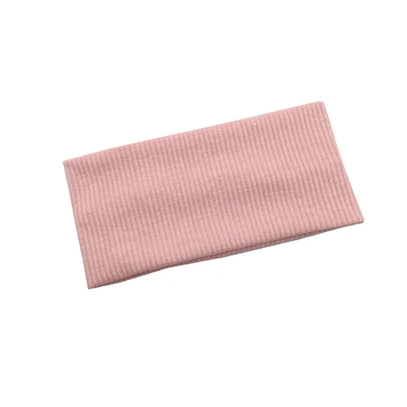 A light pink knitted sports headband for yoga and gym