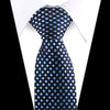 A dark blue and silver patterned silk necktie worn against a white shirt.
