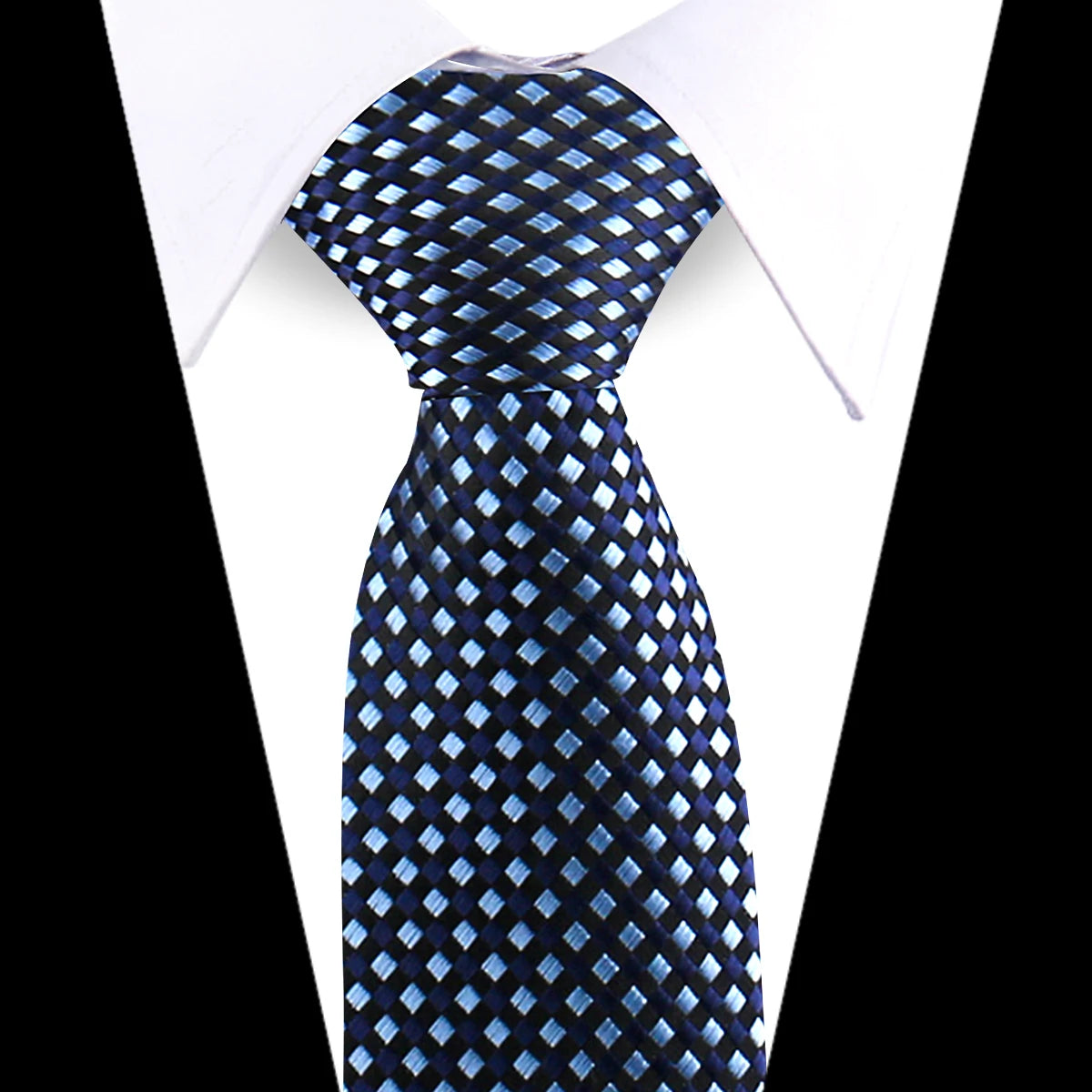 A dark blue and silver patterned silk necktie worn against a white shirt.