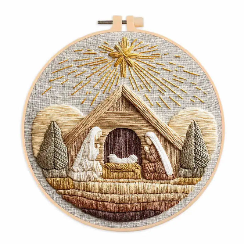 A circular embroidery kit featuring a scene of a nativity with golden rays and wooden elements.