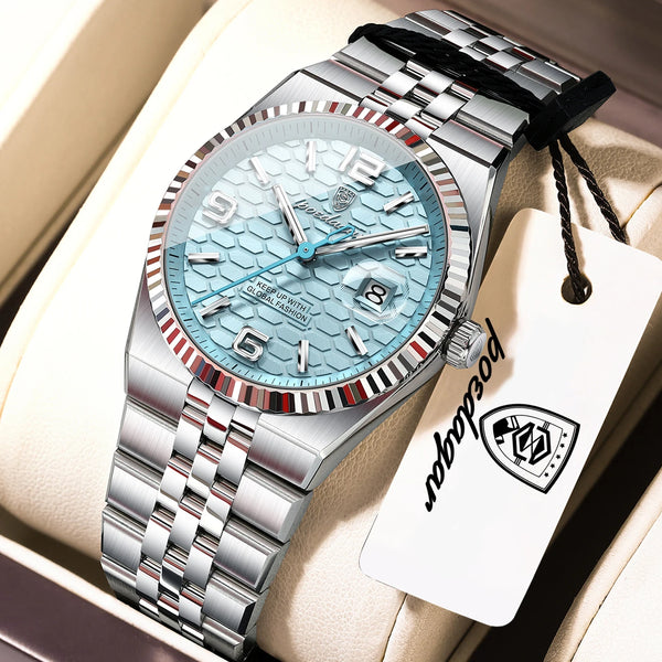 A silver-toned luxury quartz wristwatch with a light blue dial and stainless steel bracelet is displayed in a box.
