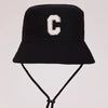 Black sun hat with a gold letter C print and an adjustable cord