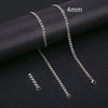 Silver stainless steel Cuban link necklace displayed on a black surface with a 4mm scale marker.