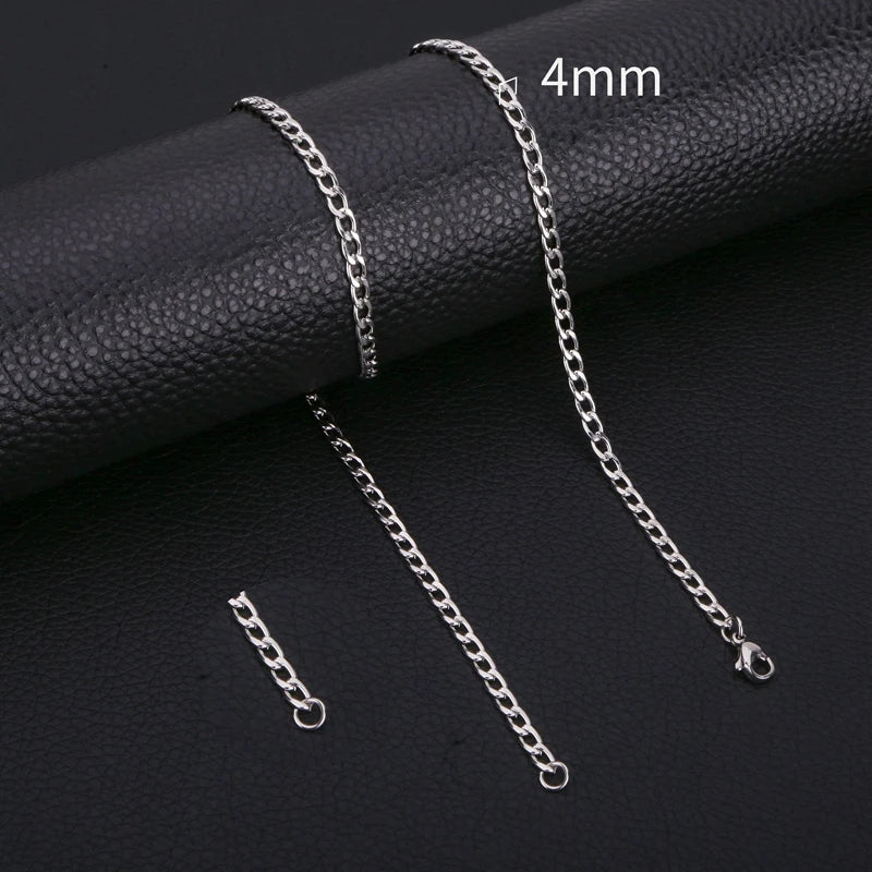 Silver stainless steel Cuban link necklace displayed on a black surface with a 4mm scale marker.