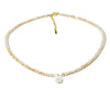 A delicate necklace made of mother of pearl beads with small crystal accents.