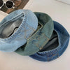 Two folded retro washed cotton denim beret hats in blue and teal colors