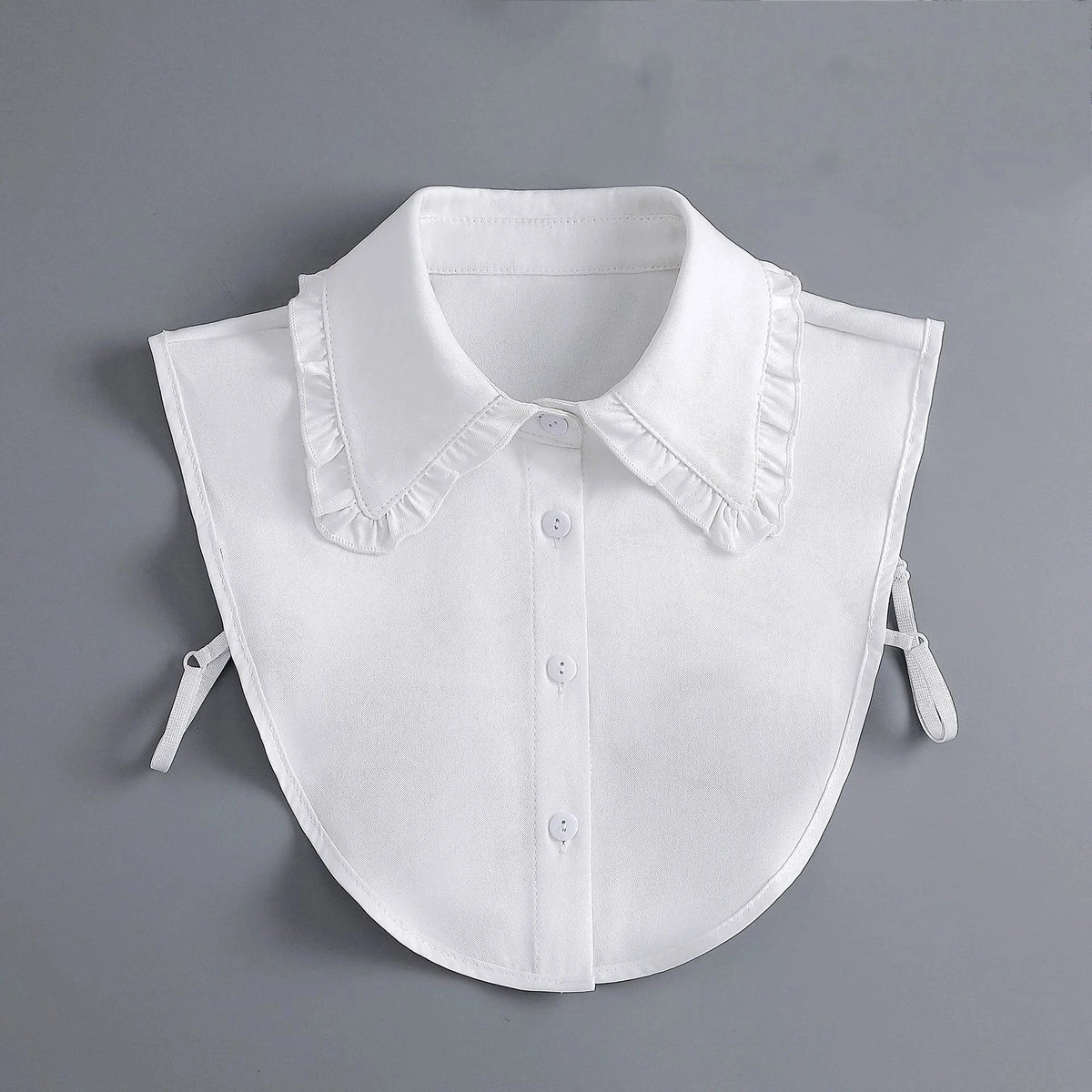 A white blouse with a fashionable false collar and detachable neckline, shown flat lay.