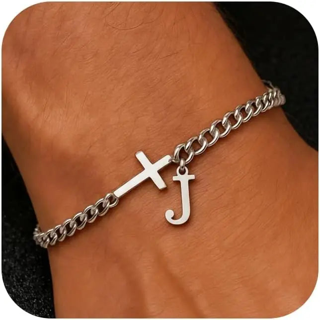 A close-up of a personalized stainless steel cross Cuban chain bracelet worn on a wrist.