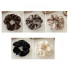Five silk scrunchie hair ties in various neutral tones including brown, gray, and beige.