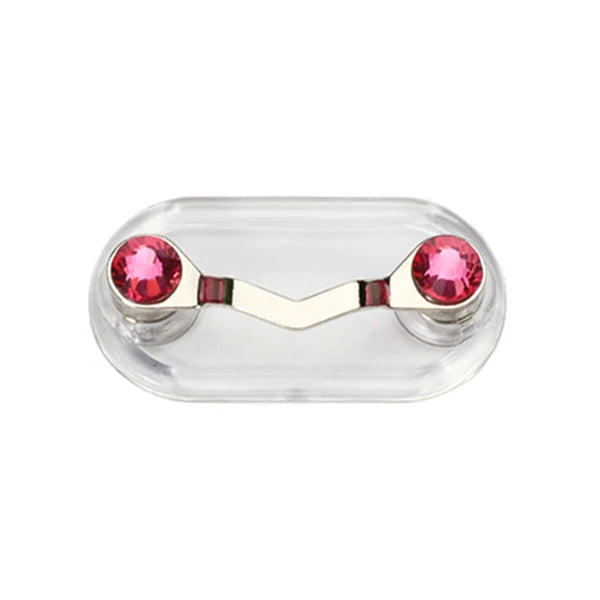 A clear plastic magnetic clip with two pink gemstones used to hold eyeglasses.