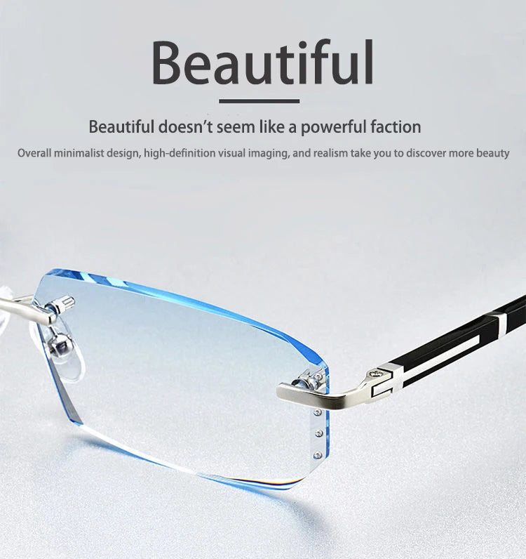 A pair of clear, frameless reading glasses with silver and black accents resting on a light gray surface.