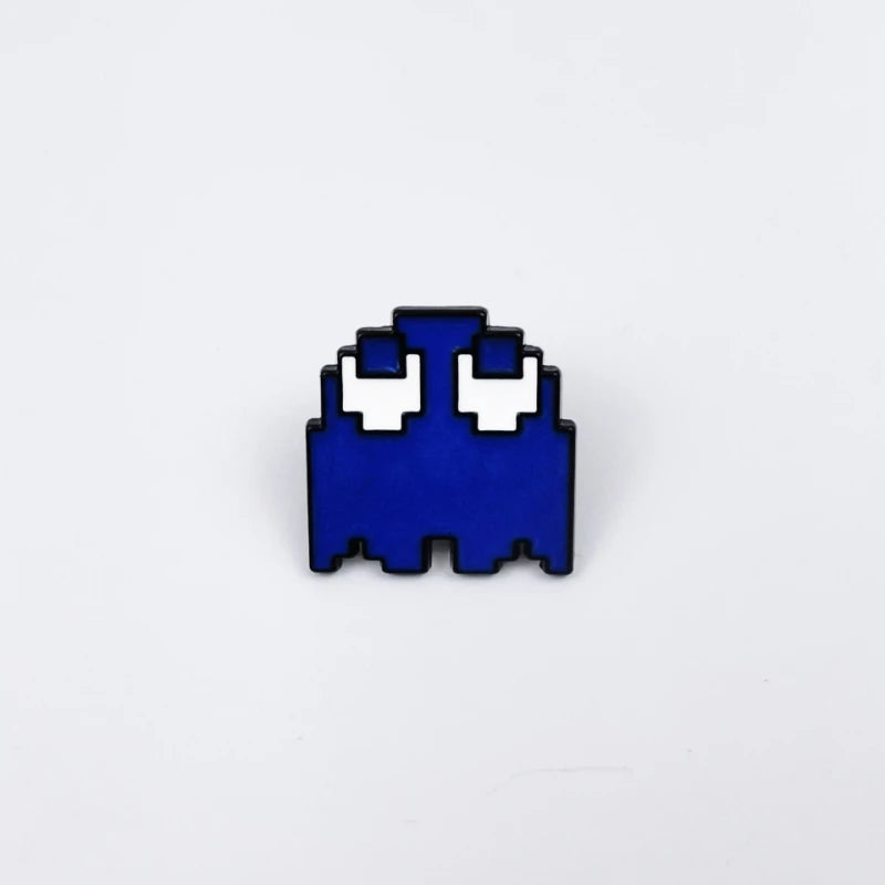 A set of three enamel pins shaped like Pac-Man ghosts in blue and white.