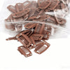 A pile of brown hair extension snap clips for wigs packaged in a clear plastic bag.